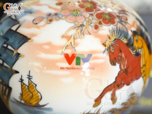 Bình hút lộc Nhị cảnh Thuận Buồm Xuôi Gió và Mã Đáo Thành Công vẽ vàng 24k in logo VTV nền cam, cao 23cm