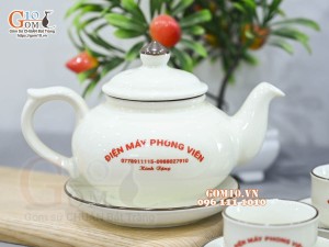 Bộ ấm chén quả hồng dẹt men kem vẽ hoa đào xanh inlogo