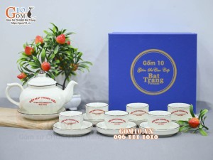 Bộ ấm chén quả hồng dẹt men kem vẽ hoa đào xanh inlogo