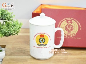 Cốc sứ dáng cao quai nắm có nắp men trắng in logo