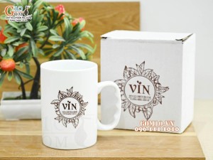 Cốc sứ dáng cao quai nắm có nắp men trắng in logo