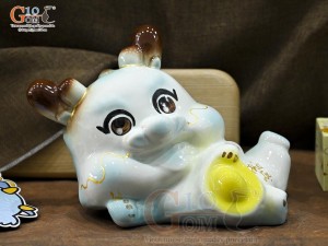 Tiểu Long tiết kiệm dáng nằm ôm vàng màu xanh, dài 25cm