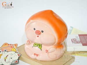 Tượng sứ tiết kiệm dáng trái đào màu cam, cao 20cm