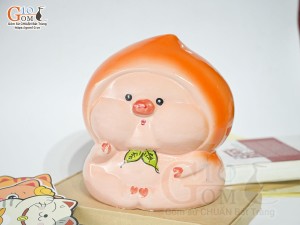 Tượng sứ tiết kiệm dáng trái đào màu cam, cao 20cm