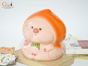 Tượng sứ tiết kiệm dáng trái đào màu cam, cao 20cm